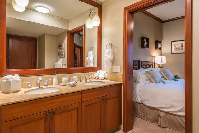 a en suite bathroom with a sink double vanity and a mirror
