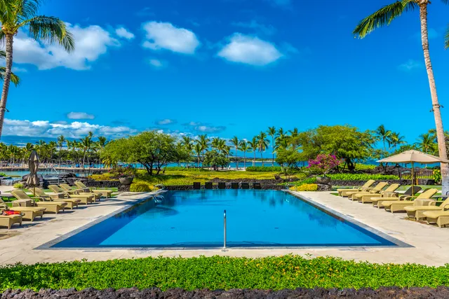 a view of a swimming pool with an outdoor seating and a yard