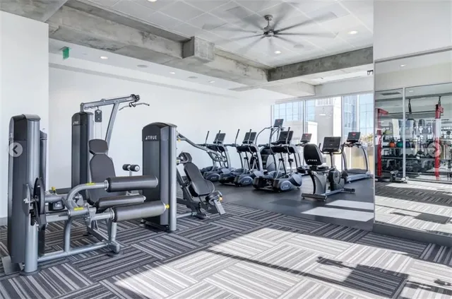 a view of a room with lots of gym equipment
