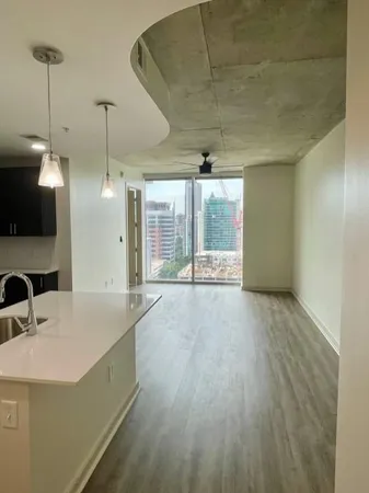 a view of a kitchen with a sink and a large window