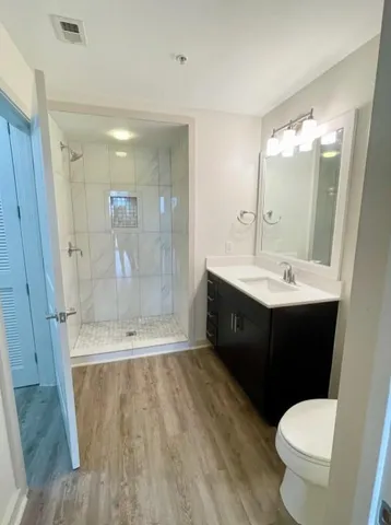 a bathroom with a double vanity sink toilet and shower