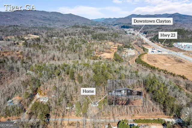 a view of a town with mountains in the background
