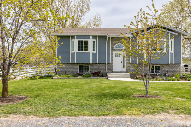 365 South Center Street Fielding, UT 84311 - Photo 2 of 41 Split foyer home featuring a front yard, brick siding, and entry steps