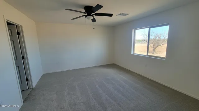 a view of a livingroom with a ceiling fan and window