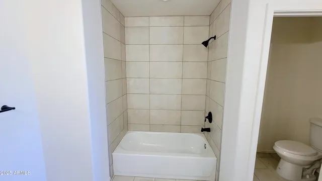 a bathroom with a shower and a toilet