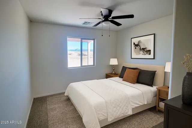 a bedroom with a large bed and a window