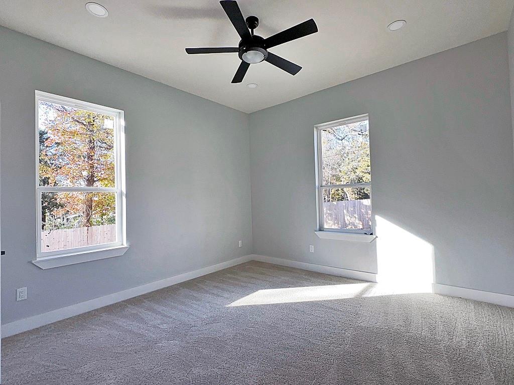 2969 Trey Circle Athens, TX 75752 - Photo 11 of 14 an empty room with windows and fan