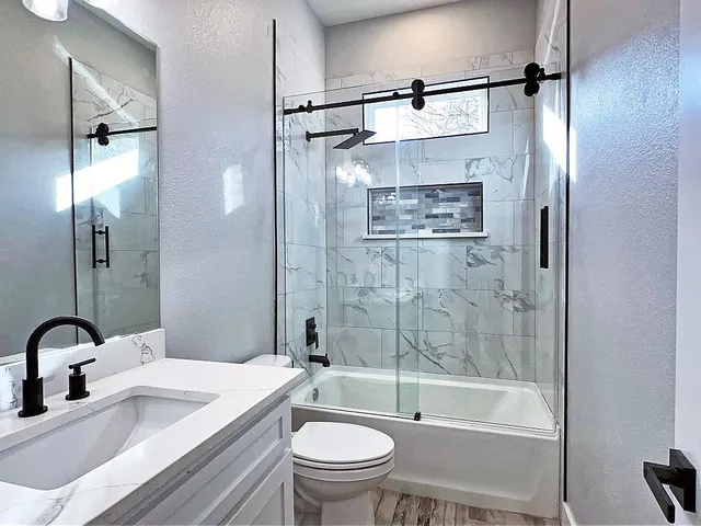 a room with a sink cabinets and wooden floor