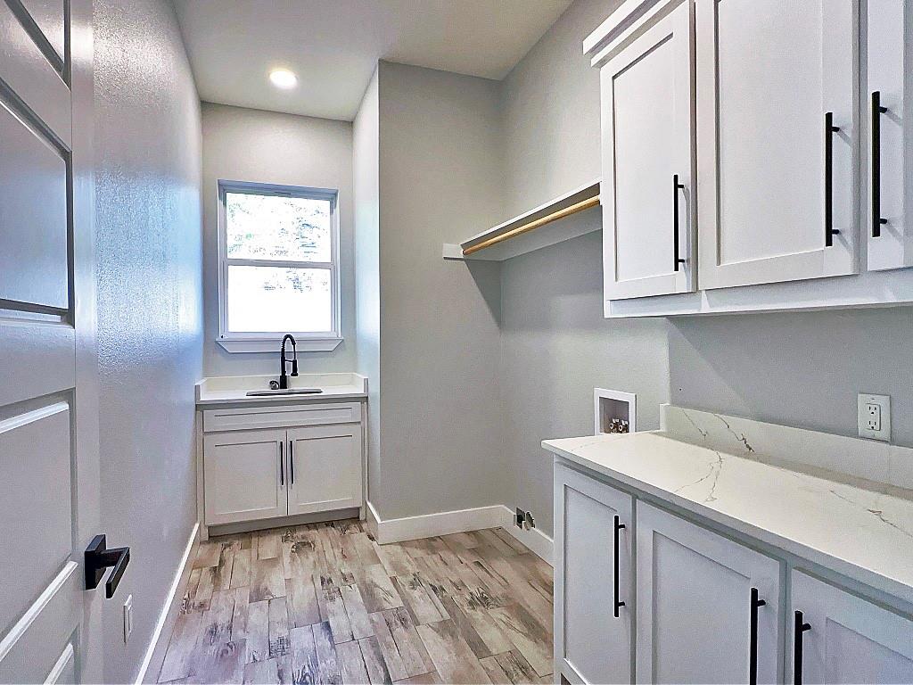 2969 Trey Circle Athens, TX 75752 - Photo 13 of 14 a room with a sink cabinets and wooden floor