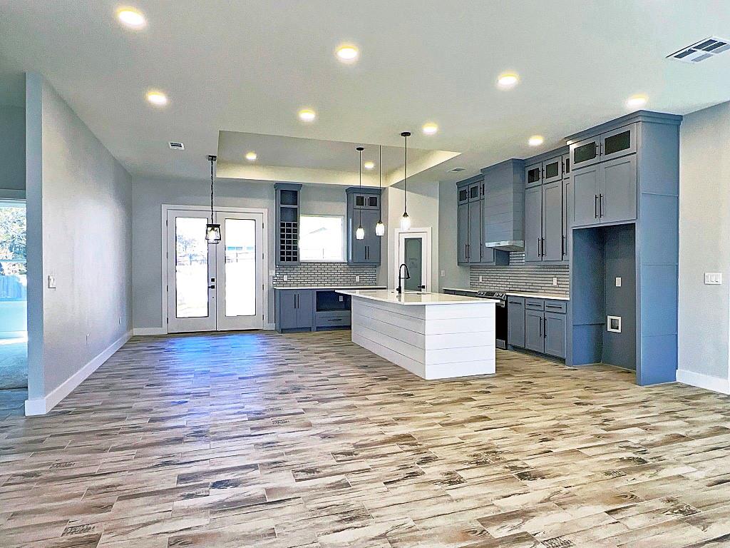 2969 Trey Circle Athens, TX 75752 - Photo 2 of 14 a large kitchen with kitchen island a sink dishwasher stove with wooden floor and cabinets