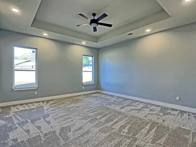 a spacious bathroom with a double vanity sink a mirror and a bathtub