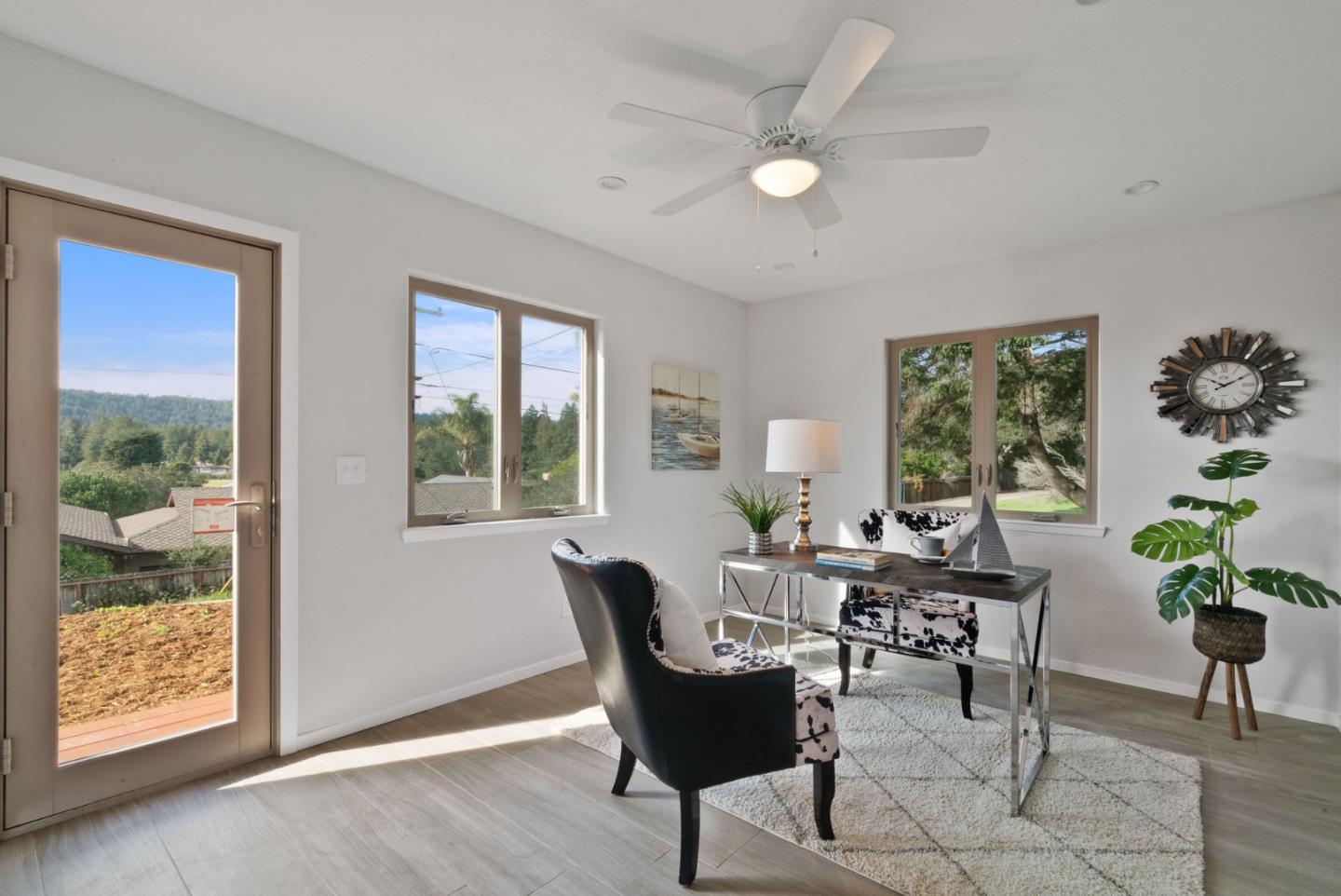 350 Sims Road Santa Cruz, CA 95060 - Photo 18 of 40 a dining room with furniture potted plants and wooden floor