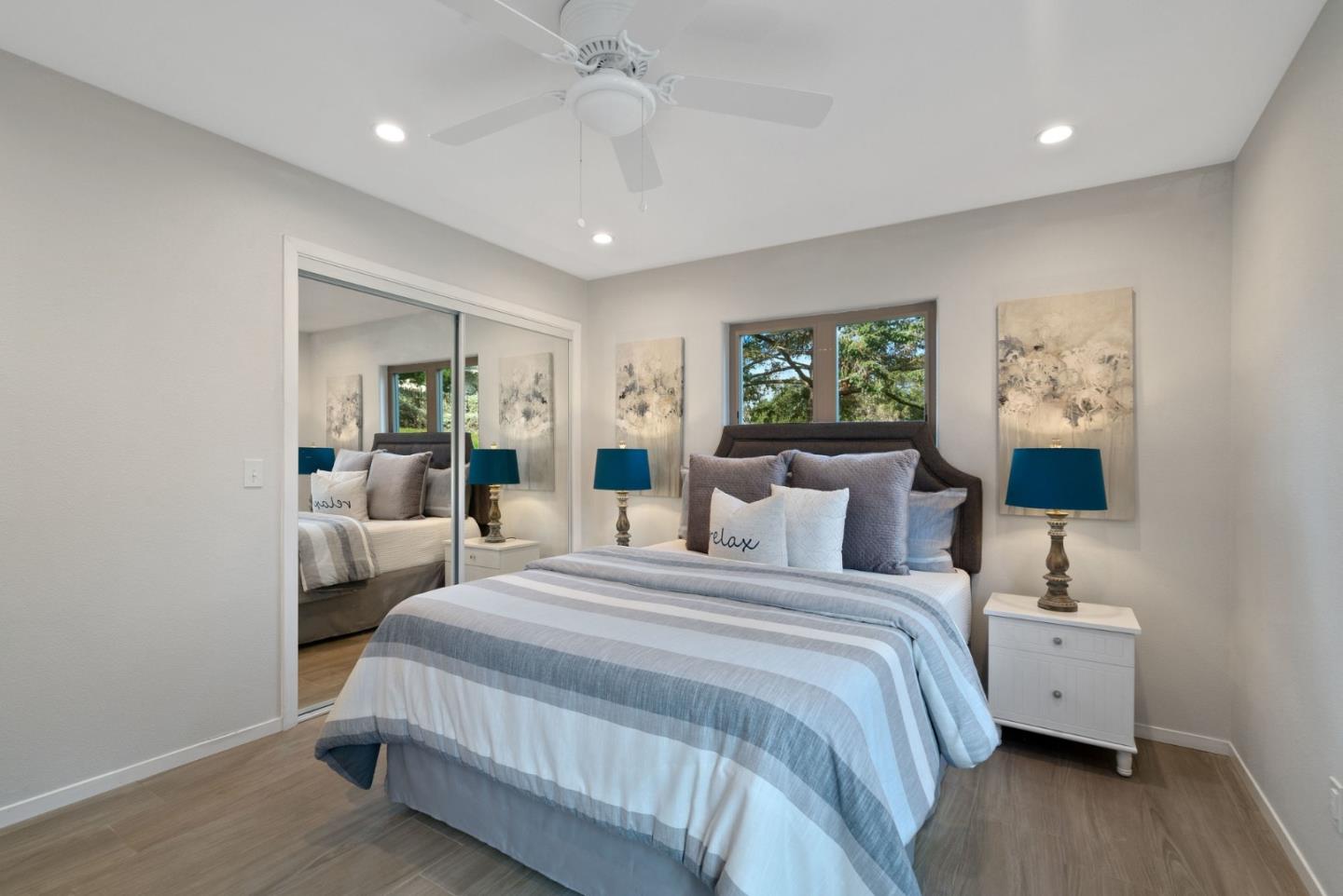 350 Sims Road Santa Cruz, CA 95060 - Photo 22 of 40 a bedroom with a large bed and a chandelier