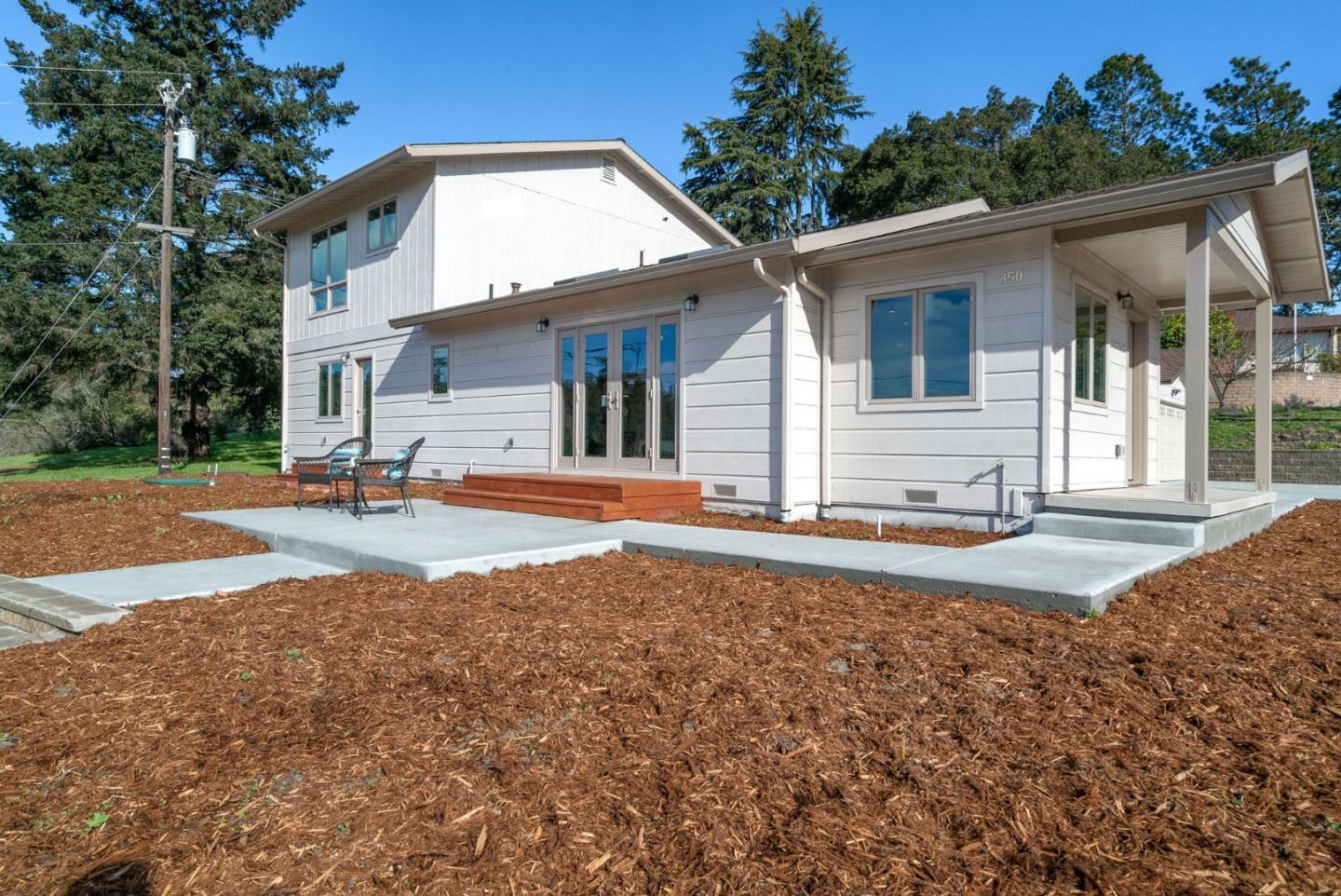 350 Sims Road Santa Cruz, CA 95060 - Photo 37 of 40 a view of a white house with large windows and a small yard