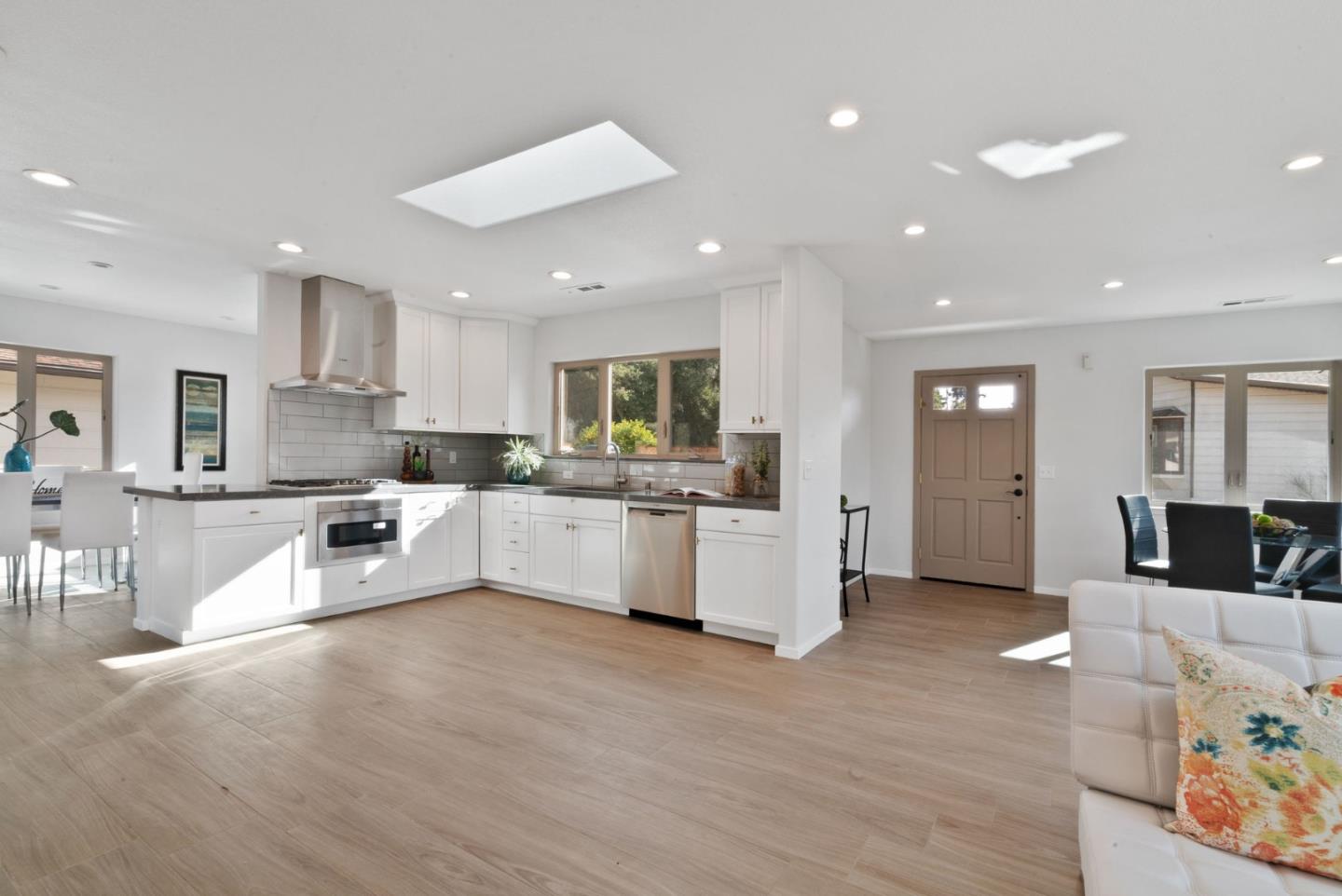 350 Sims Road Santa Cruz, CA 95060 - Photo 10 of 40 a large white kitchen with kitchen island a counter top space a sink a refrigerator and a couch