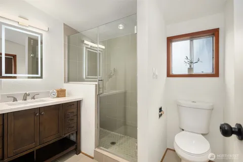 a bathroom with a toilet sink and shower