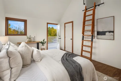a bedroom with a bed and a painting on the wall
