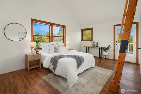 a bedroom with a large bed and a window