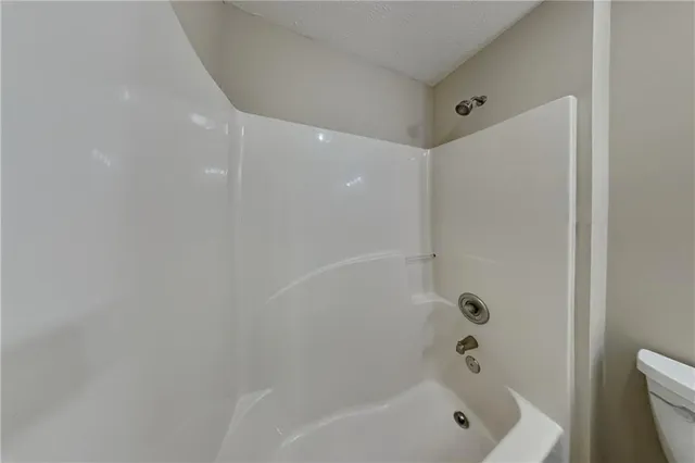 a bathroom with a bathtub and shower