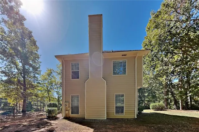 a view of a brick house with a large windows and a tree