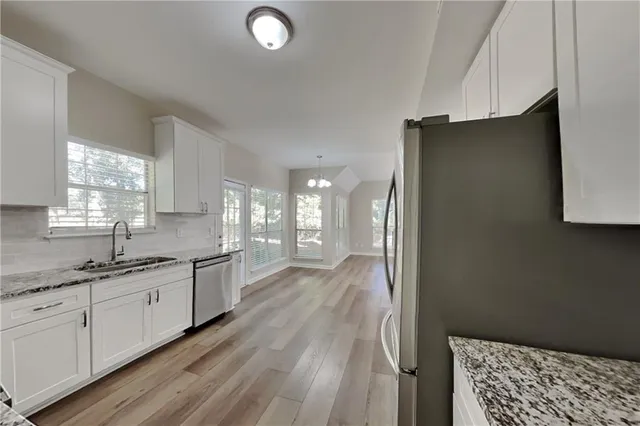 a large bathroom with a sink a mirror and a shower