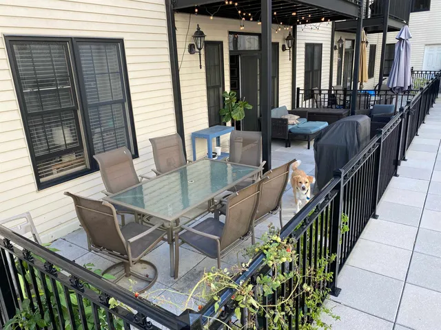 a view of a patio with table and chairs