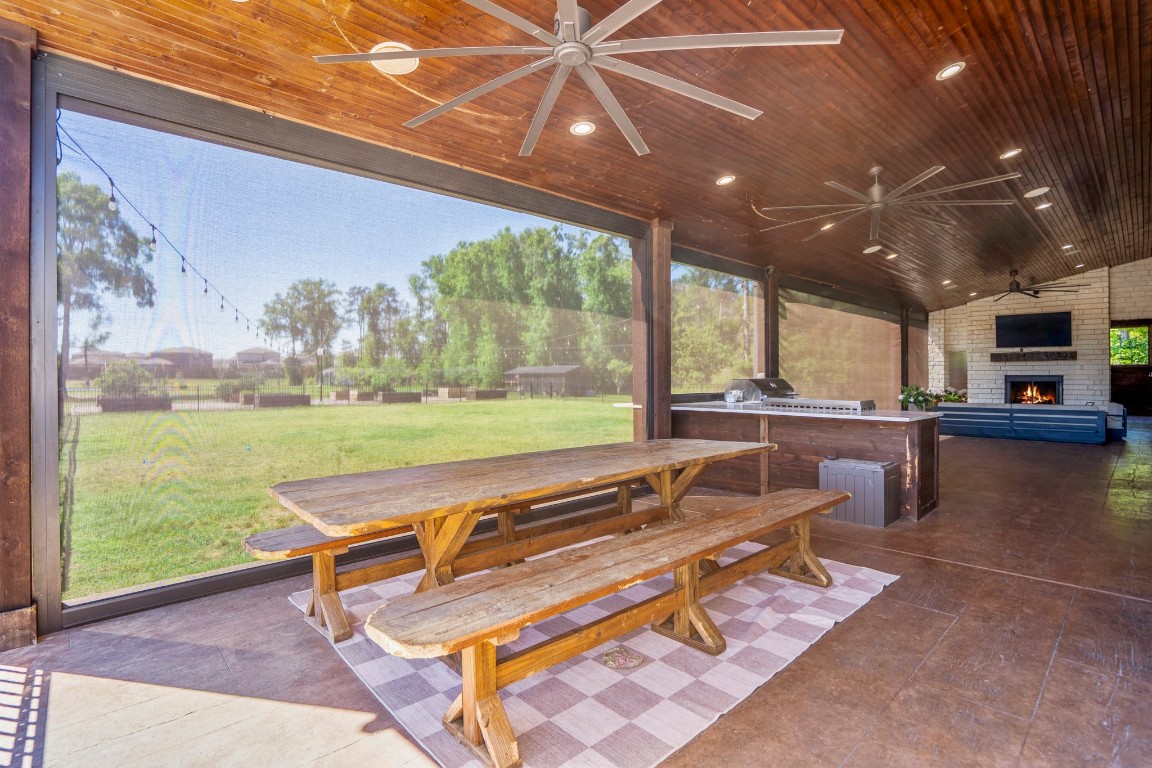 14972 Quinette Road Conroe, TX 77302 - Photo 30 of 50 Outside seating area on rear patio and woodburning fireplace