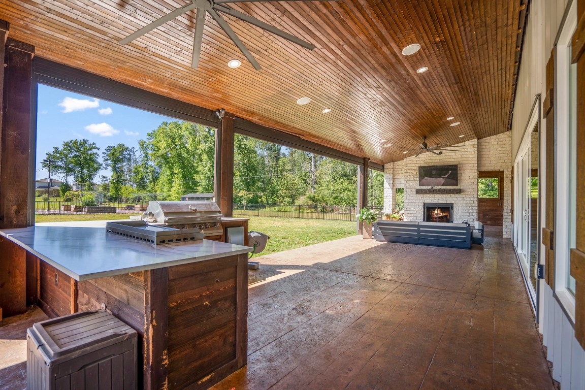 14972 Quinette Road Conroe, TX 77302 - Photo 31 of 50 Outside seating area on rear patio and woodburning fireplace