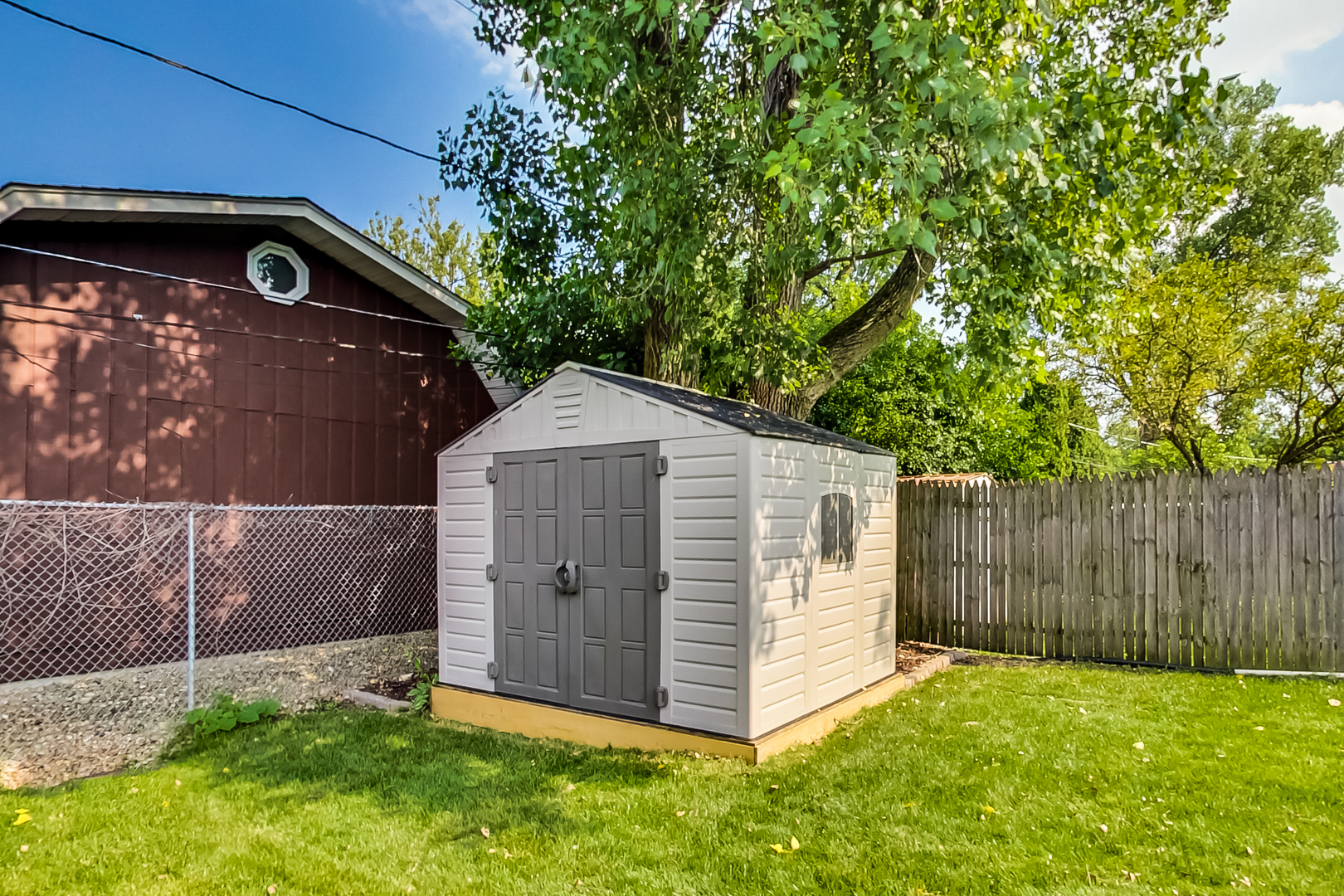 217 Troy Lane Lombard, IL 60148 - Photo 27 of 30 a view of backyard with small cabin and wooden fence