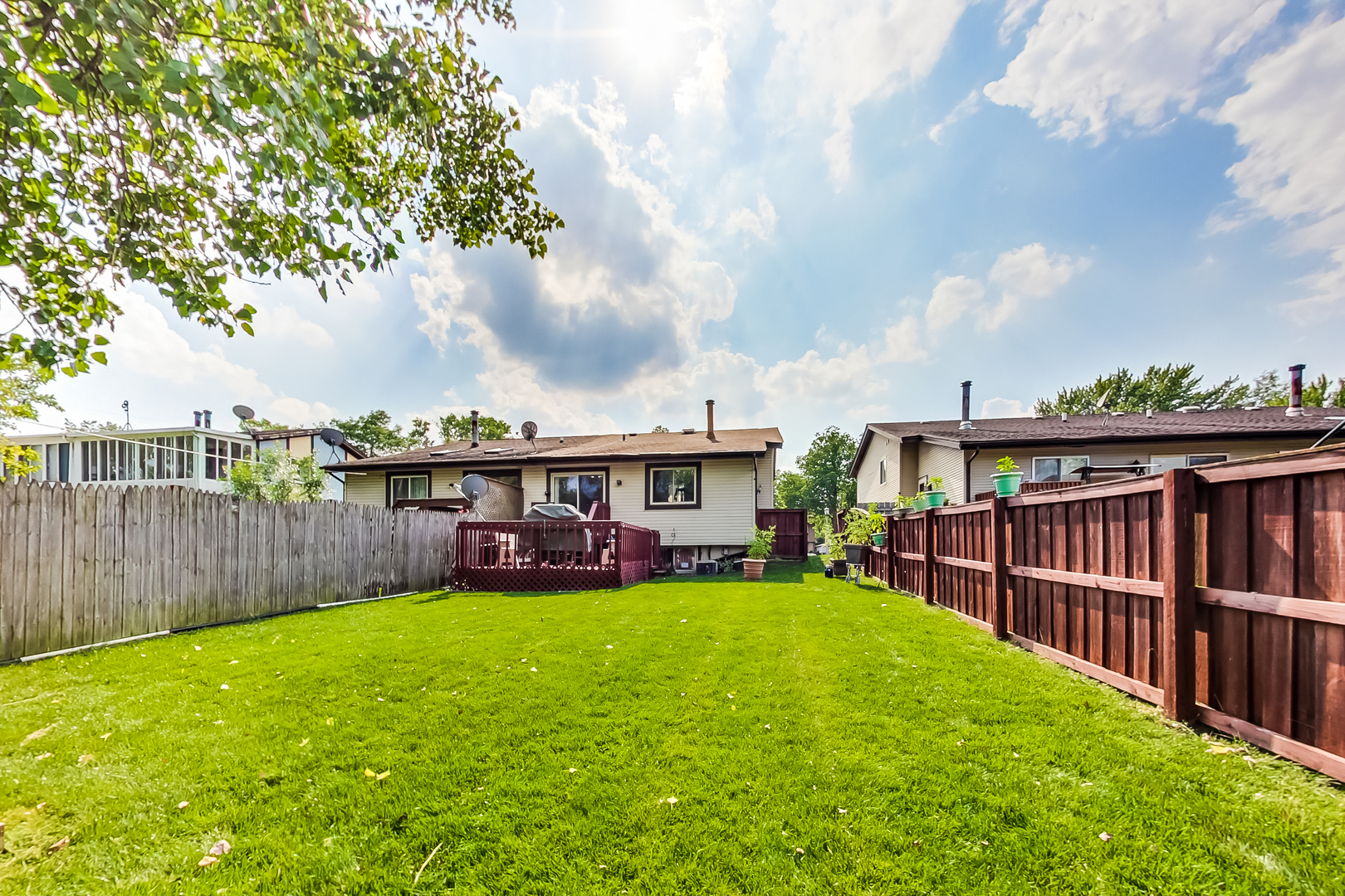 217 Troy Lane Lombard, IL 60148 - Photo 28 of 30 a view of a house with a big yard and wooden fence