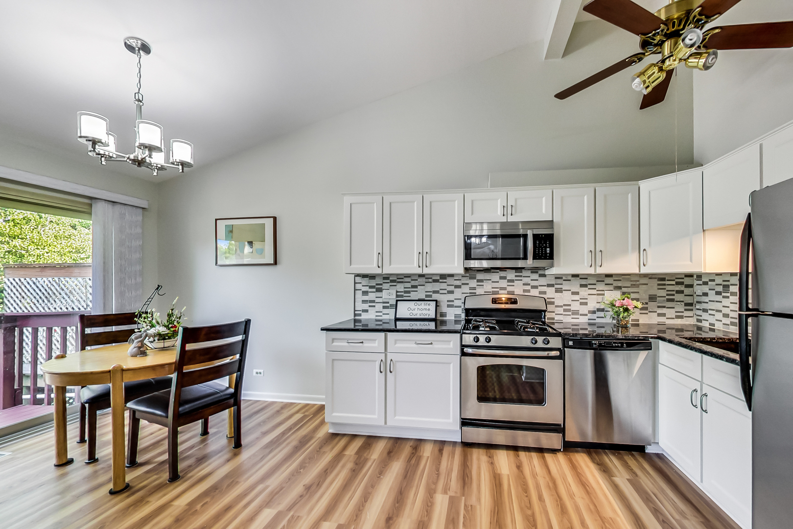 217 Troy Lane Lombard, IL 60148 - Photo 5 of 30 a kitchen with stainless steel appliances a kitchen island hardwood floor sink stove dining table and chairs