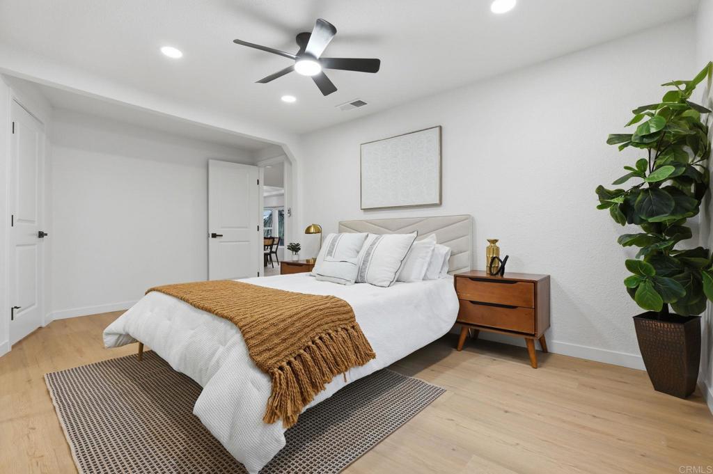 1333 Helix Street Spring Valley, CA 91977 - Photo 27 of 45 a bedroom with a bed and a potted plant