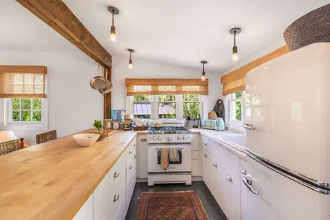 a kitchen with sink stove and refrigerator