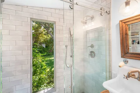 a bathroom with a shower and a sink