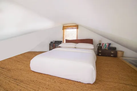a bedroom with a bed and window
