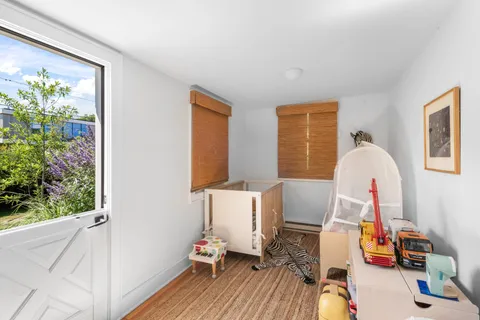 a view of a room with toys and wooden floor