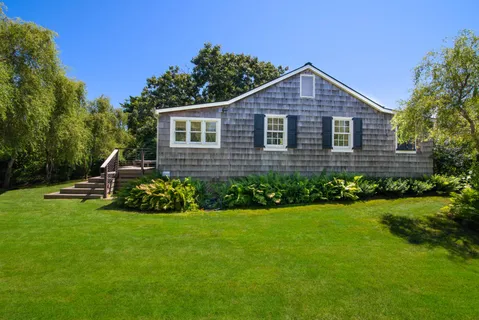 a front view of a house with a yard and pathway