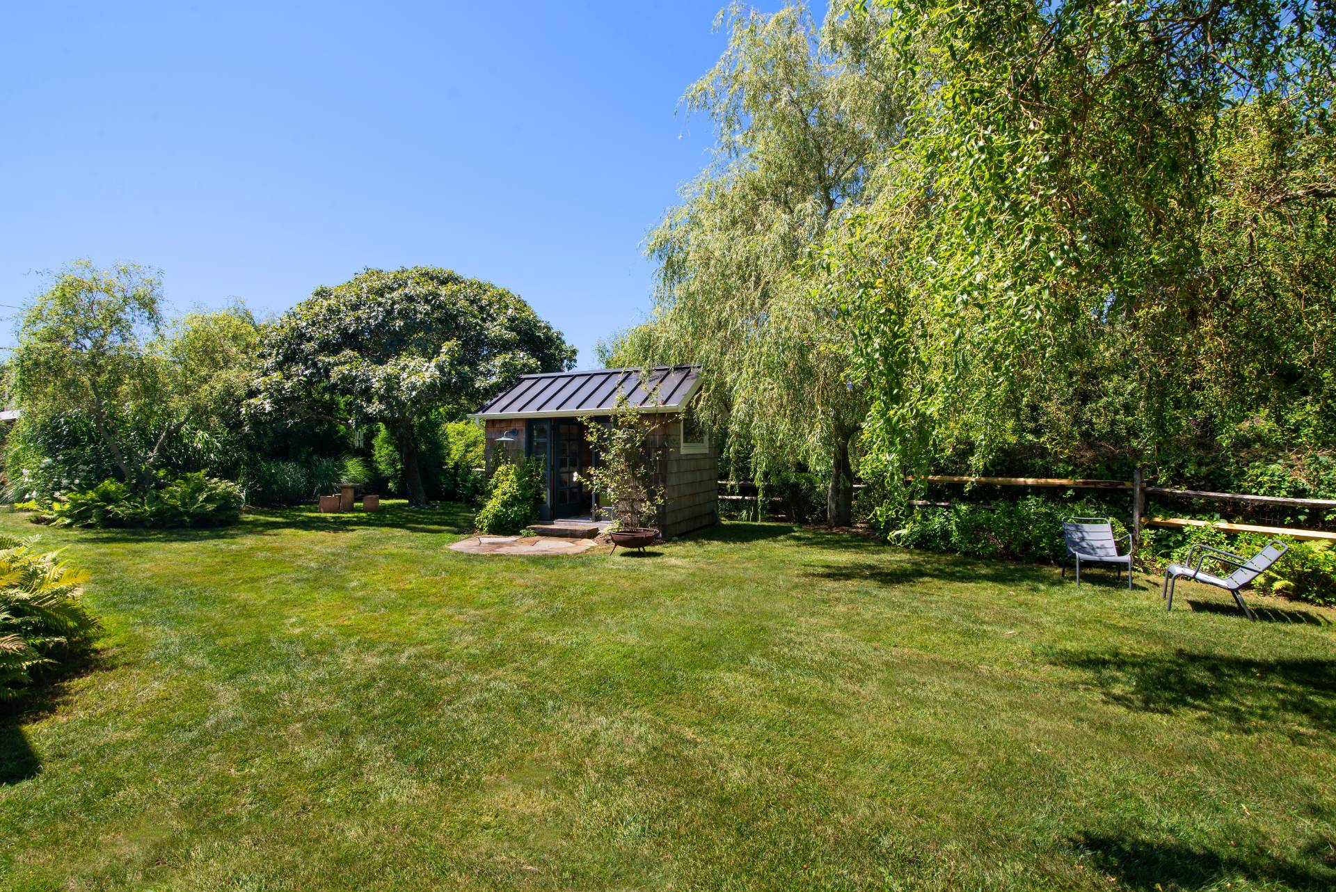 12 Jackson Road Montauk, NY 11954 - Photo 23 of 36 a view of a swimming pool with lawn chairs under an umbrella