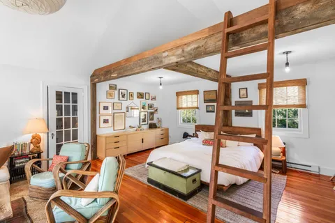 a living room with furniture a table and chairs