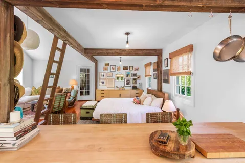 a bedroom with a bed couch and window