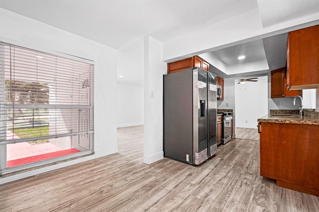 7007 Northwest 64th Street Tamarac, FL 33321 - Photo 13 of 41 a view of a kitchen with wooden floor and a refrigerator