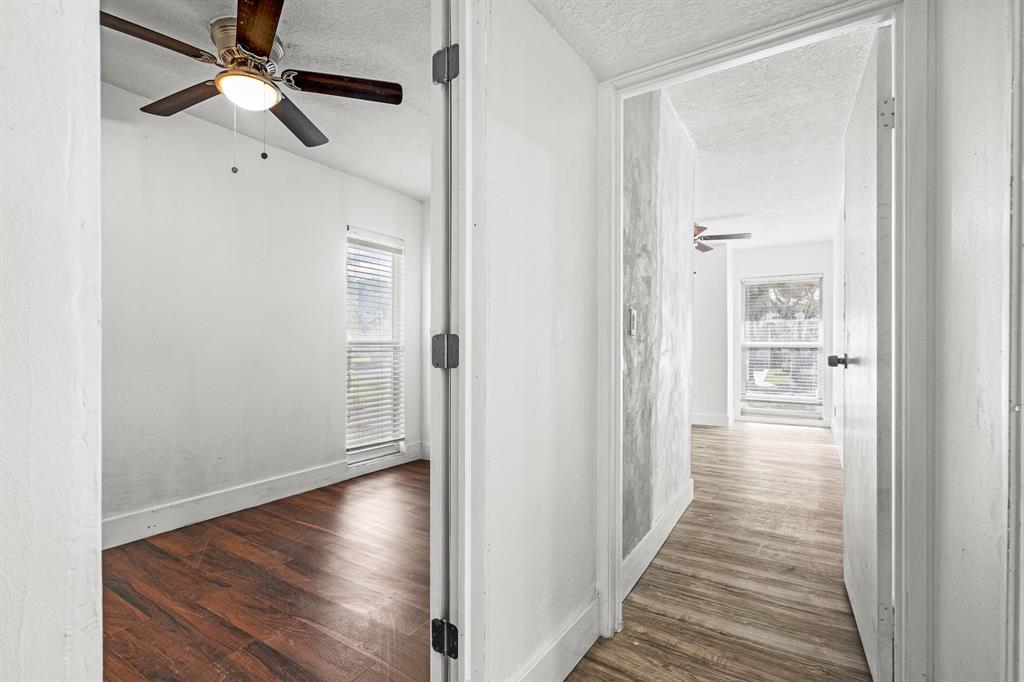 7007 Northwest 64th Street Tamarac, FL 33321 - Photo 16 of 41 a view of a hallway with wooden floor and a chandelier