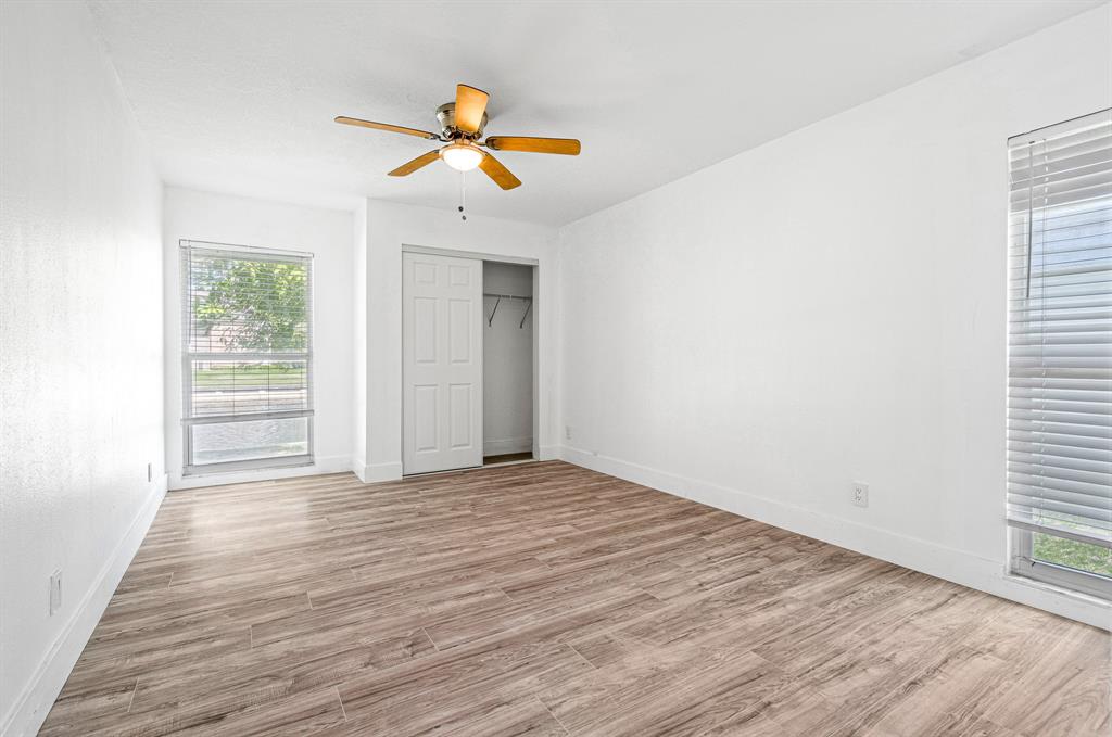 7007 Northwest 64th Street Tamarac, FL 33321 - Photo 22 of 41 a view of empty room with wooden floor and fan