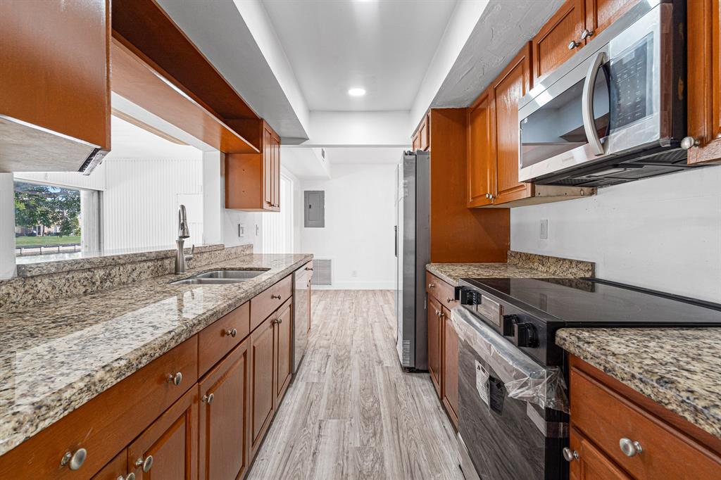 7007 Northwest 64th Street Tamarac, FL 33321 - Photo 31 of 41 a kitchen with stainless steel appliances granite countertop a stove and a sink