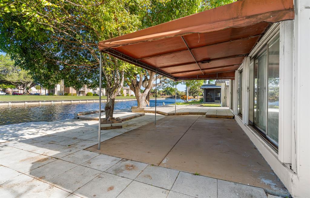 7007 Northwest 64th Street Tamarac, FL 33321 - Photo 34 of 41 a view of a patio with table and chairs under an umbrella