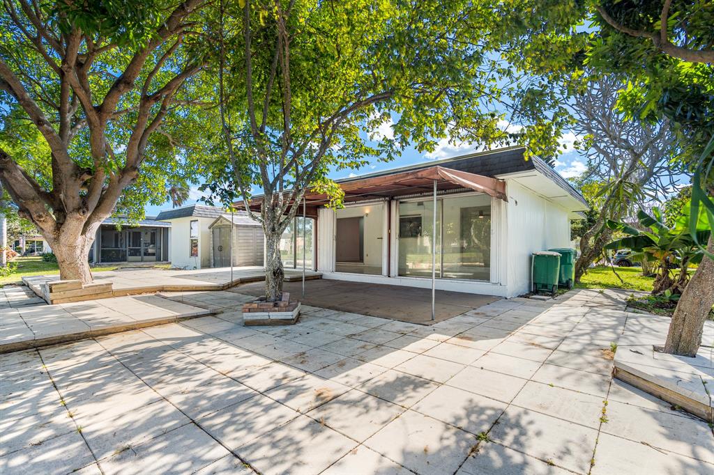 7007 Northwest 64th Street Tamarac, FL 33321 - Photo 35 of 41 a front view of a house with a yard and garage