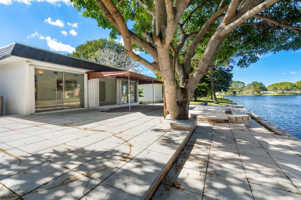 7007 Northwest 64th Street Tamarac, FL 33321 - Photo 37 of 41 a front view of a house with a yard