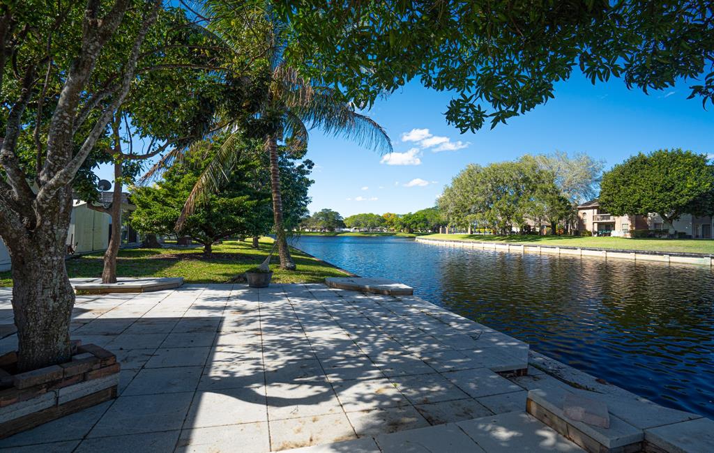 7007 Northwest 64th Street Tamarac, FL 33321 - Photo 40 of 41 a view of a lake with a yard