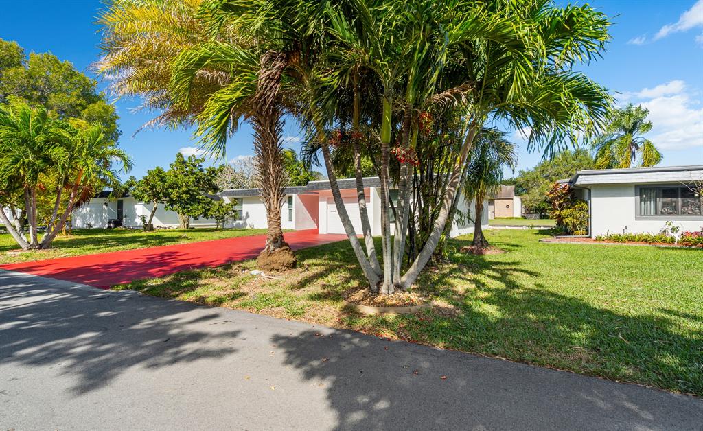 7007 Northwest 64th Street Tamarac, FL 33321 - Photo 4 of 41 a view of a house with a yard and tree s