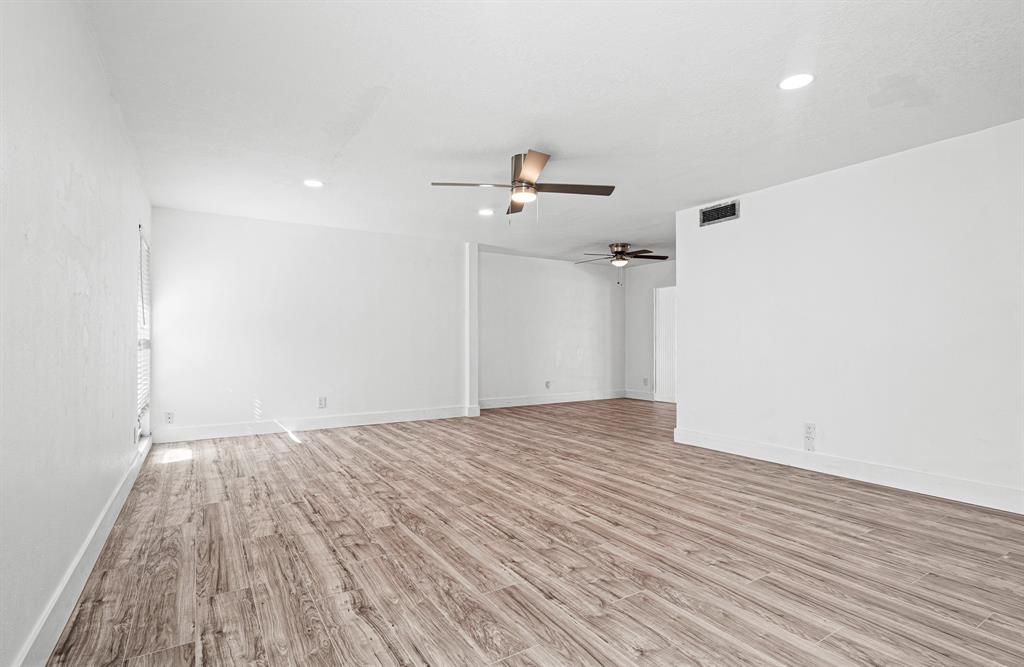 7007 Northwest 64th Street Tamarac, FL 33321 - Photo 9 of 41 a view of a room with wooden floor and a ceiling fan